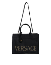 Bolso tote cruzado Versace de lona y cuero con asa superior en color negro y logotipo