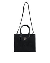 Bolso tote cruzado Versace de lona y cuero con asa superior en color negro y logotipo