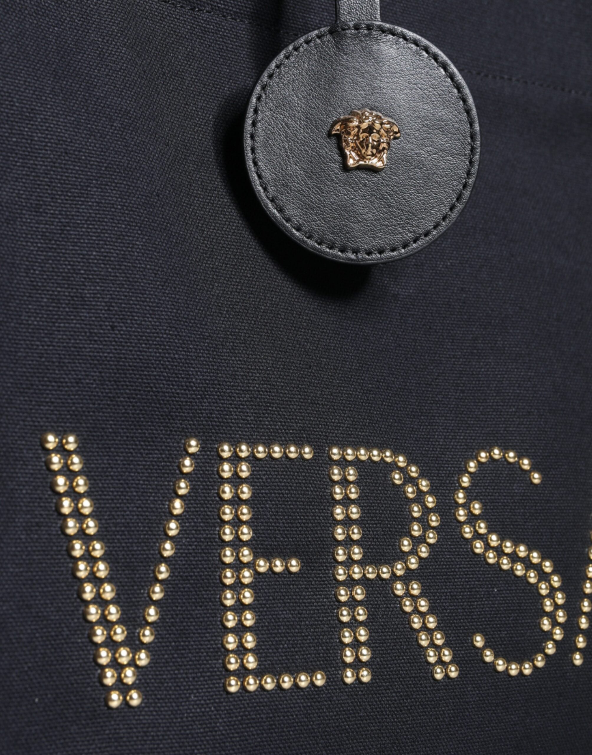 Bolso tote cruzado Versace de lona y cuero con asa superior en color negro y logotipo