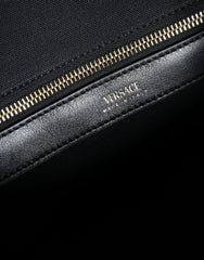 Bolso tote cruzado Versace de lona y cuero con asa superior en color negro y logotipo